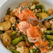 Salmon asparagus sheet pan in a bowl.