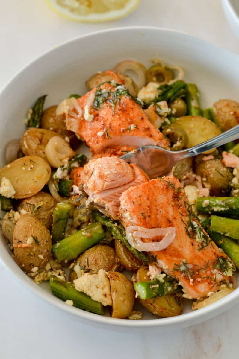 Salmon asparagus sheet pan in a bowl.