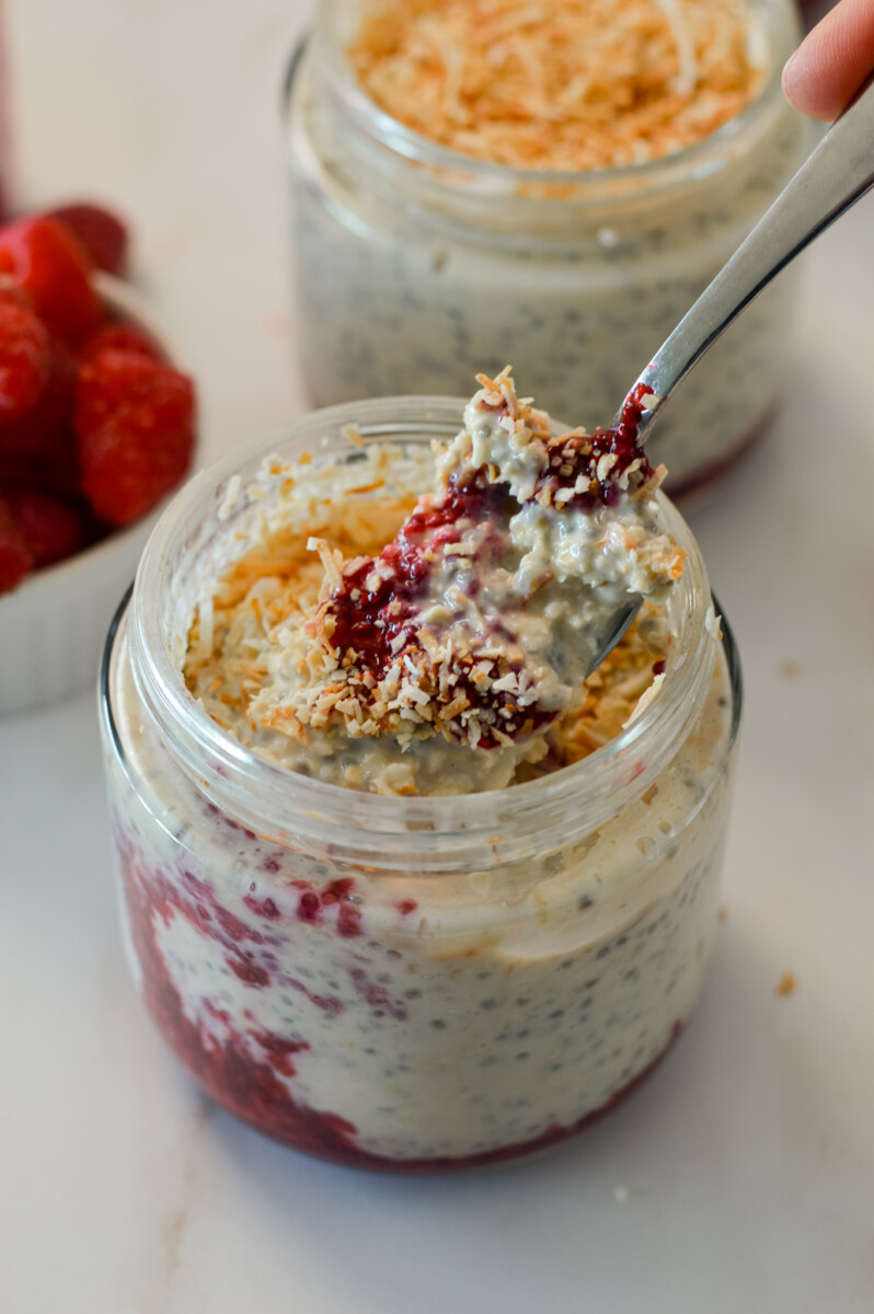 Spoon lifting up oats out of a jar.