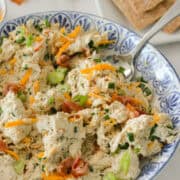 High-protein chicken bacon ranch chicken salad in a bowl with a spoon lifting it up.