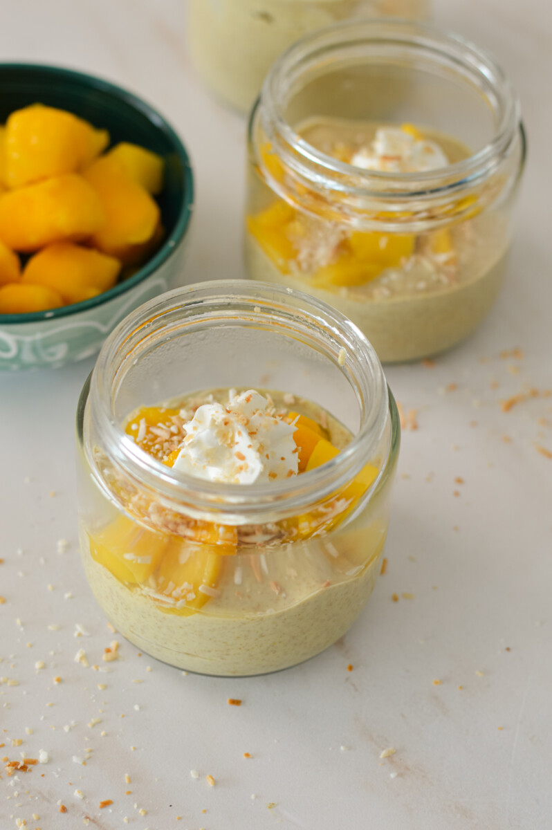 Mango chia pudding in glass jars.