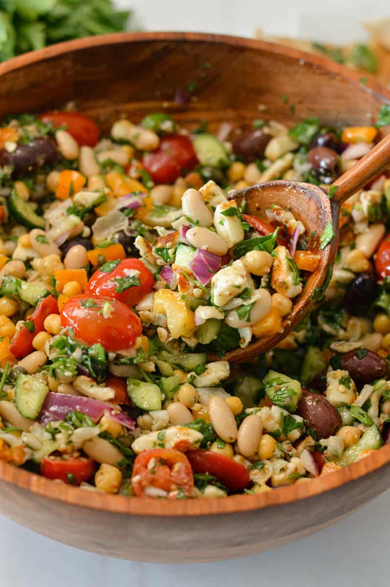 Spoon lifting up a scoop of high fiber taverna salad.