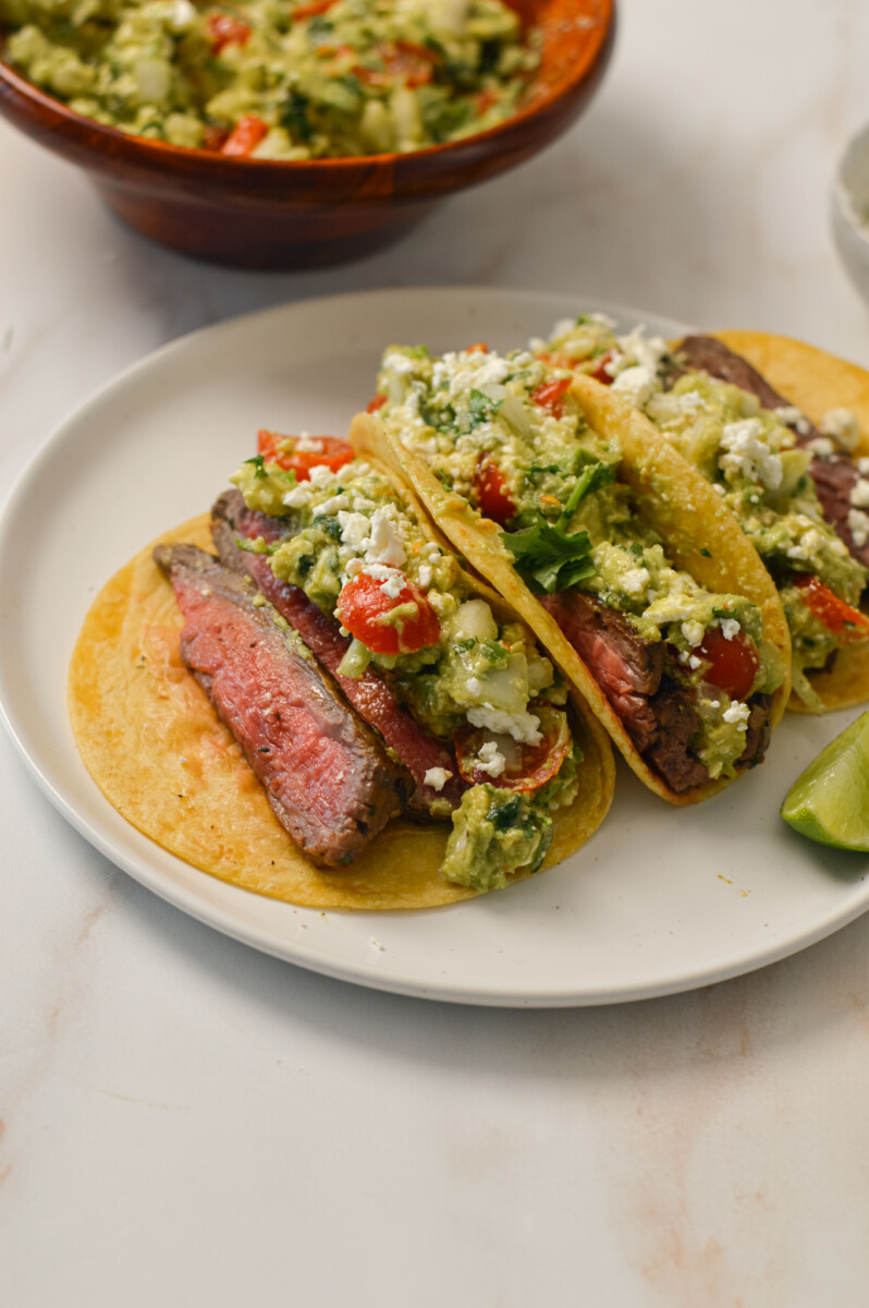 Flank steak tacos on a plate.