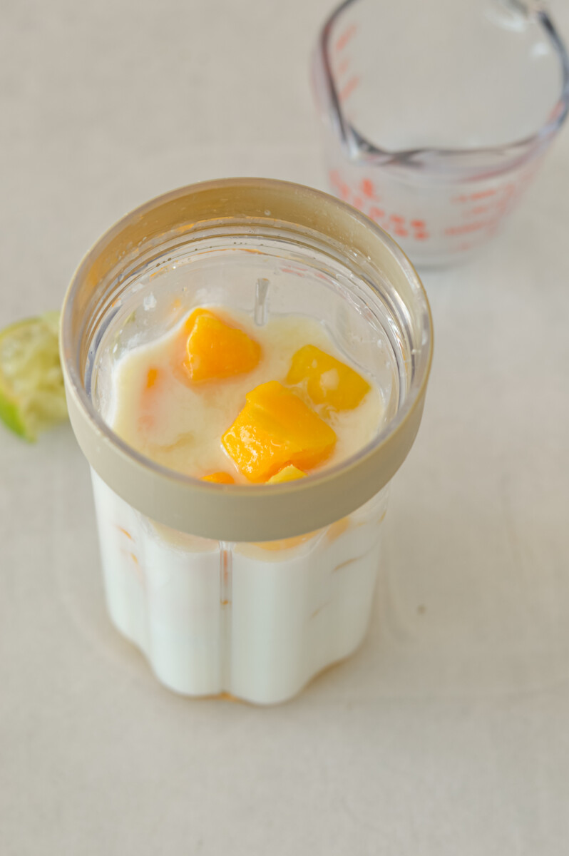 Ingredients for the mango chia pudding in a blender.