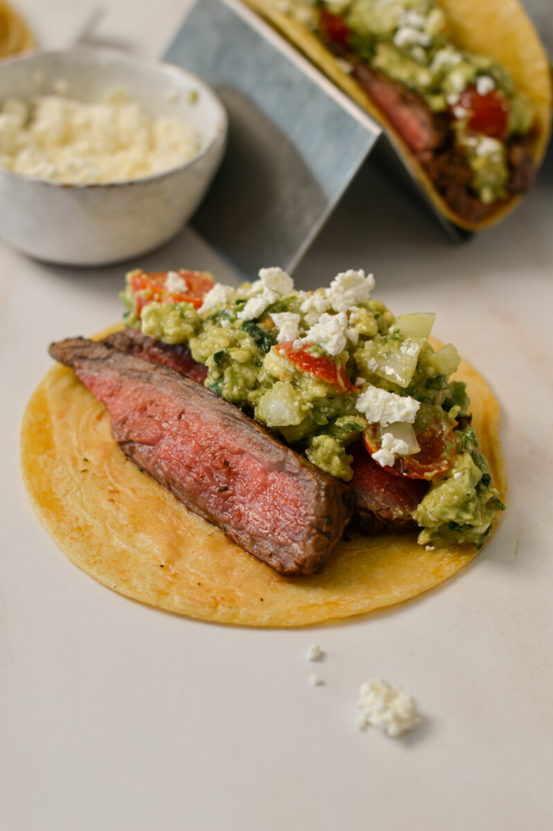 Steak taco being assembled.