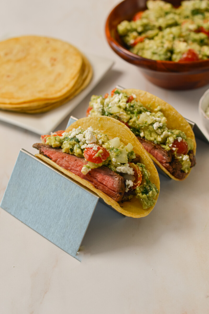 Two carne asada tacos on a tray.