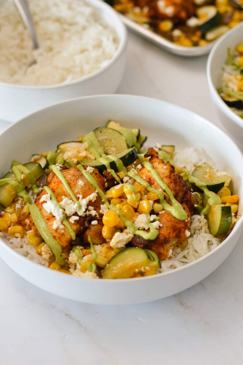 Street corn chicken rice bowls topped with avocado crema.