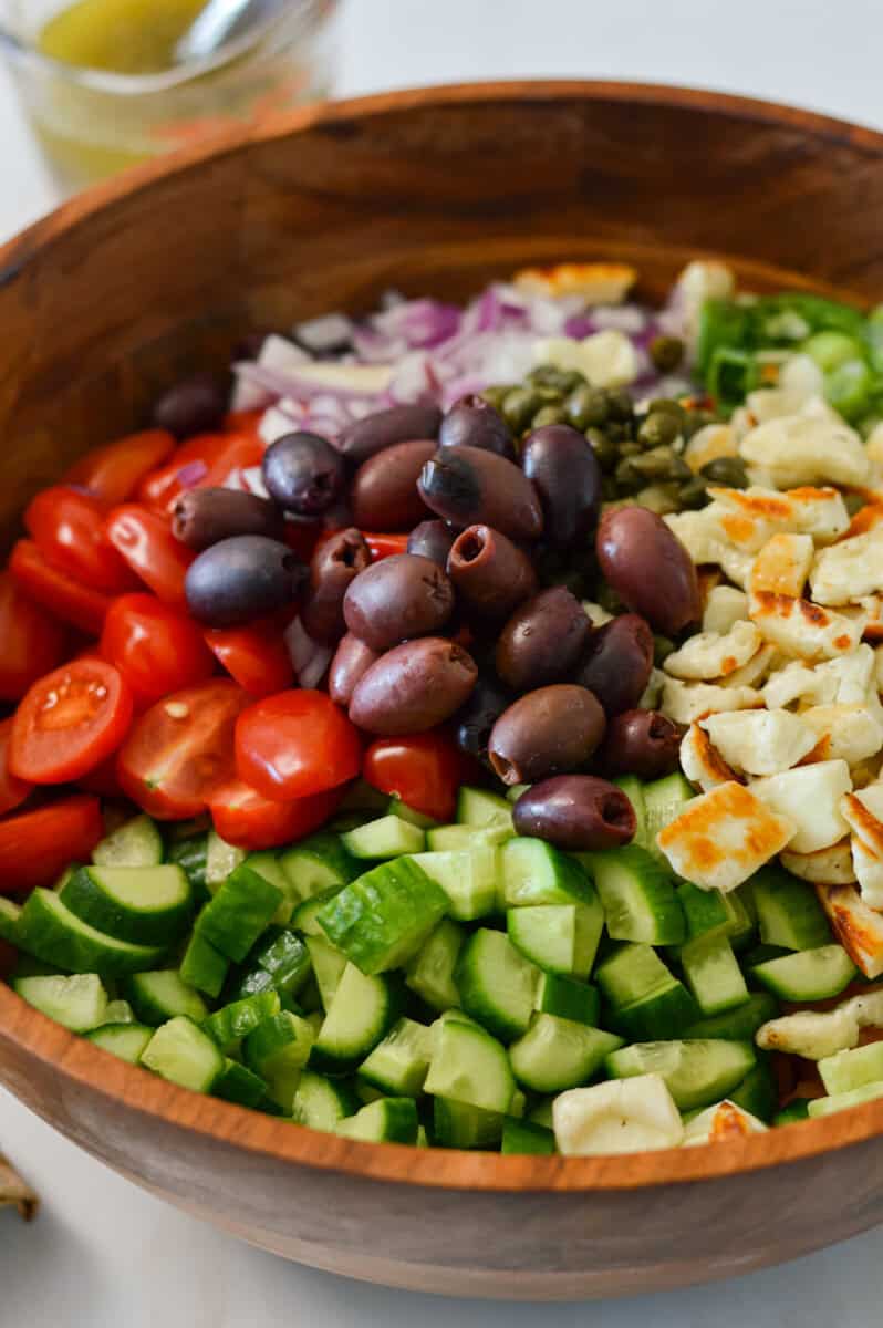 Ingredients for the taverna salad in a large serving bowl.