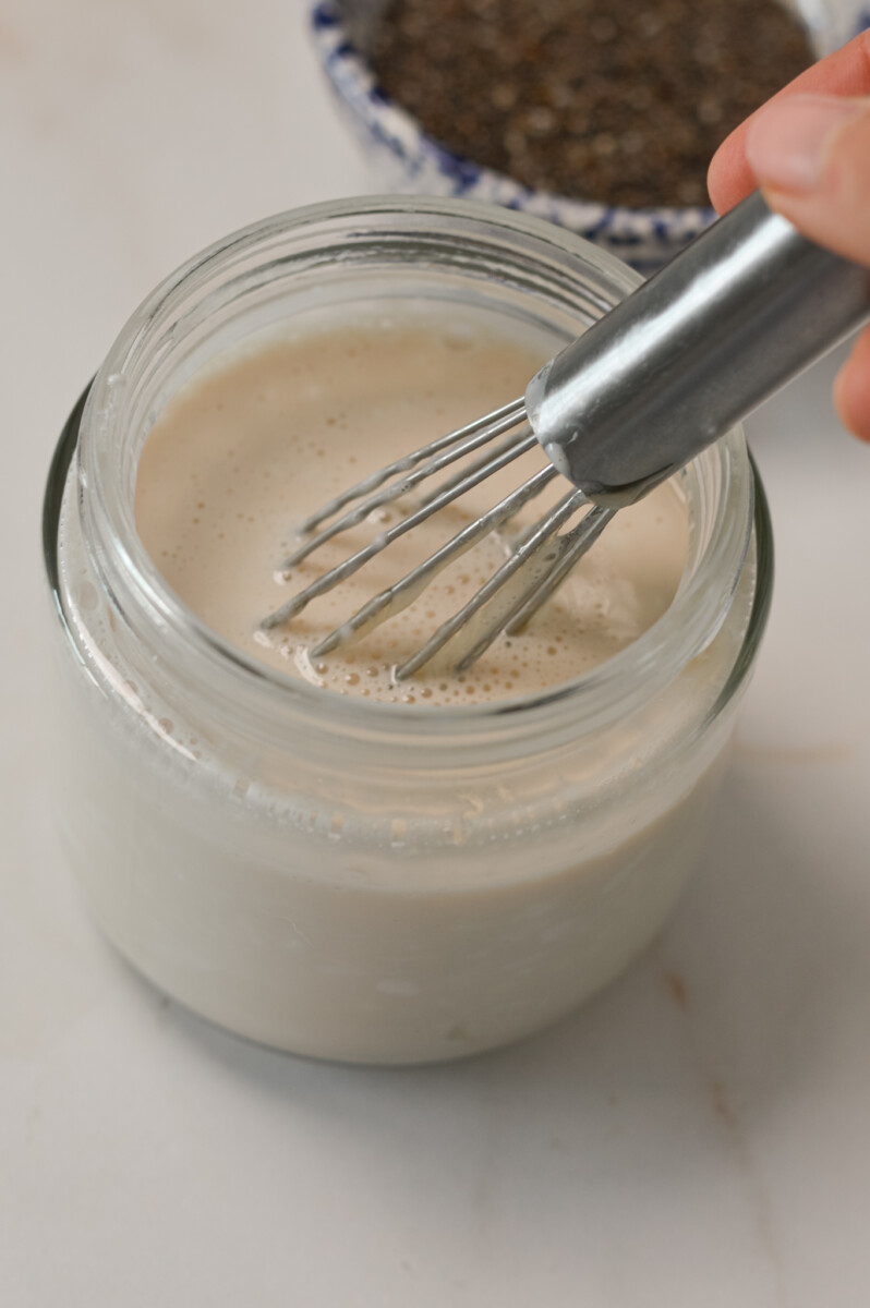 Wet ingredients being mixed in a small jar.