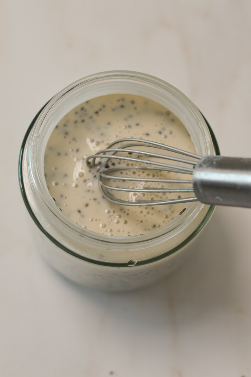 Chia seeds added to the small jar and being whisked with the Greek yogurt mixture.
