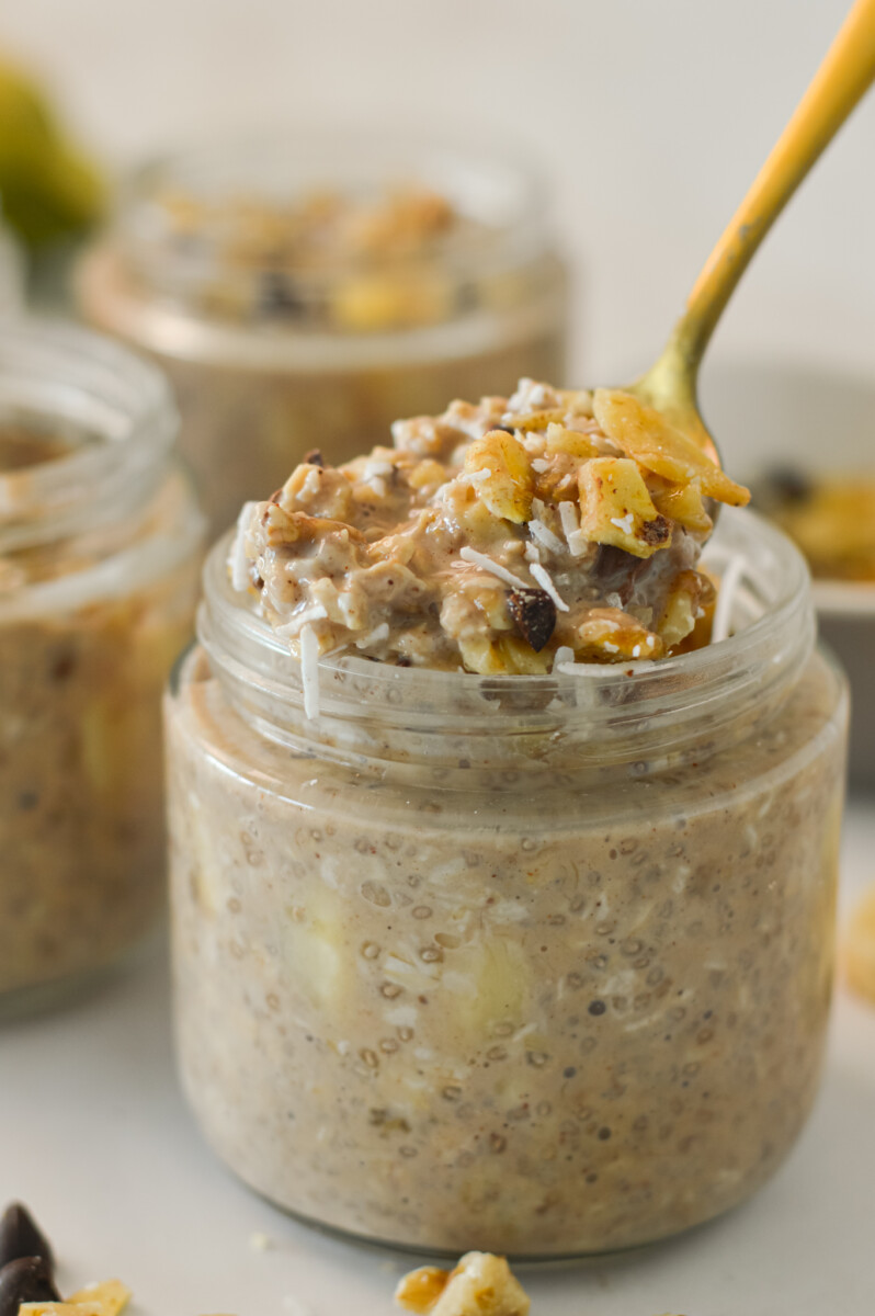 Close up of overnight oats with a spoon lifting a bite.