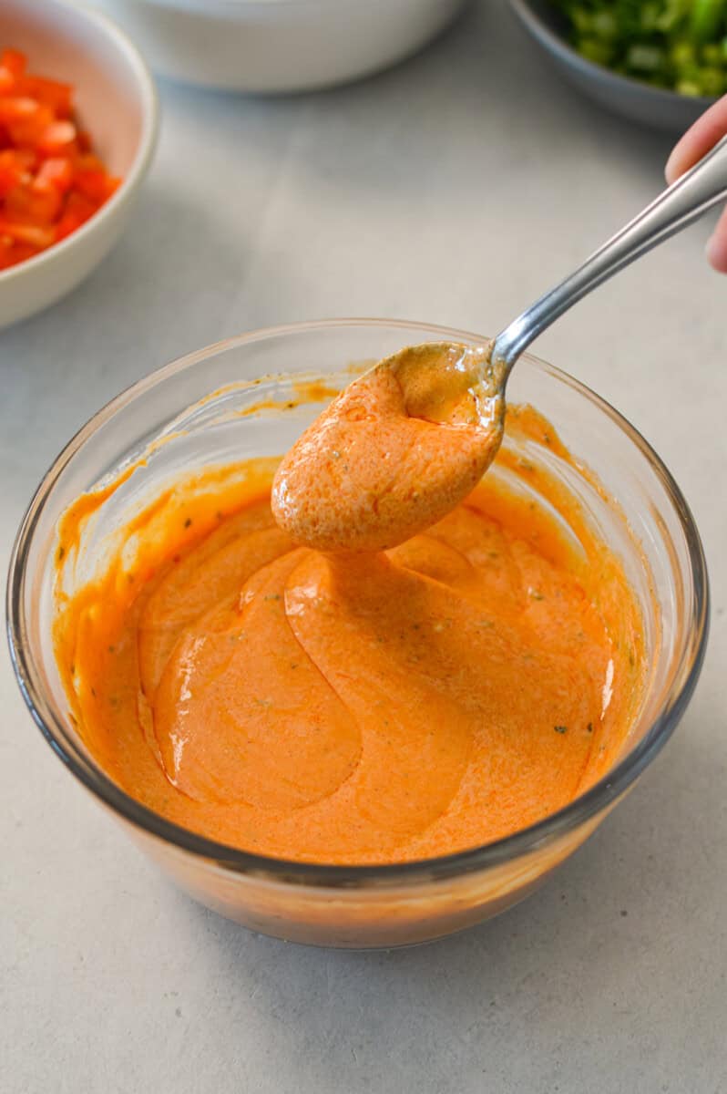 Greek yogurt buffalo dressing in a small bowl.
