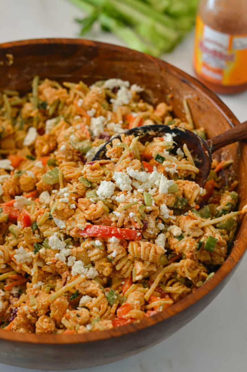 Buffalo chicken pasta salad after being tossed and ready to be served for high protein lunches.