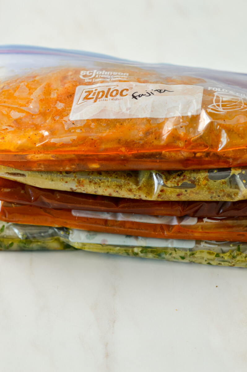 Chicken marinades stacked in Ziploc bags.