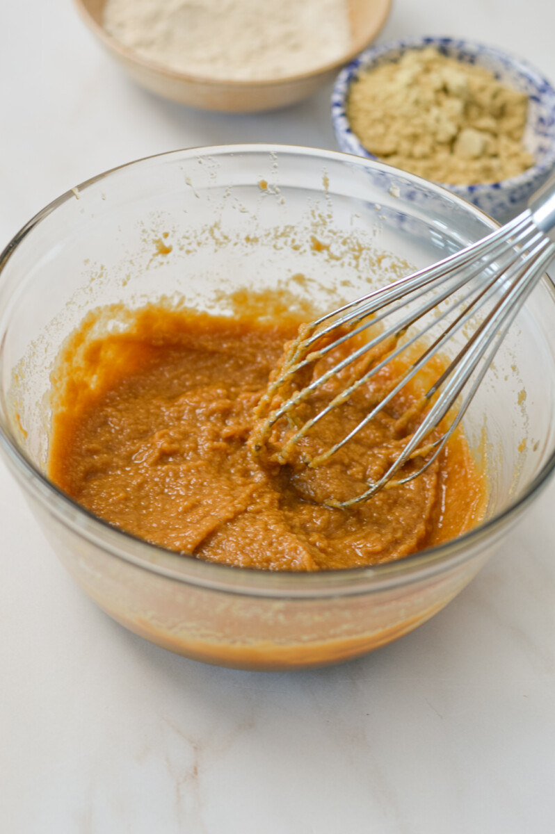 Wet ingredients for cookie dough combined in a mixing bowl.
