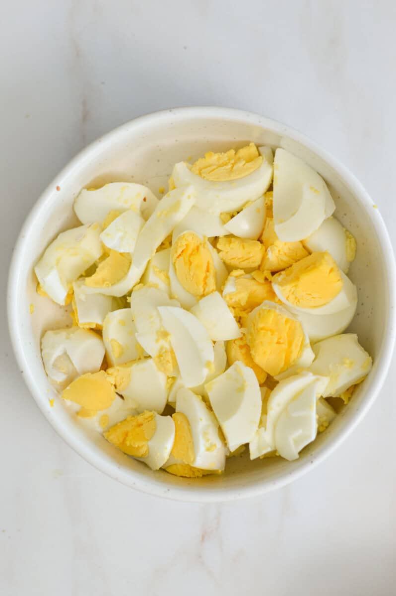 Hard boiled eggs chopped in a bowl.
