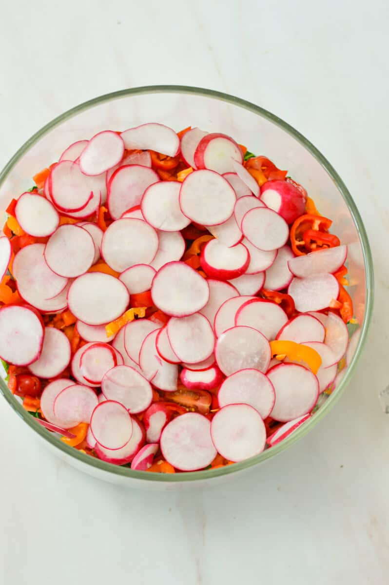 Vegetables added to the layered salad.