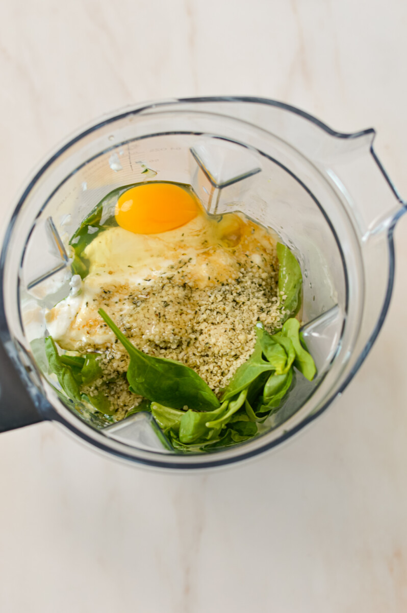 Wet ingredients and veggies added to a blender.