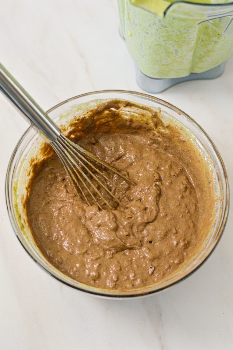 Wet and dry ingredients combined in a mixing bowl.