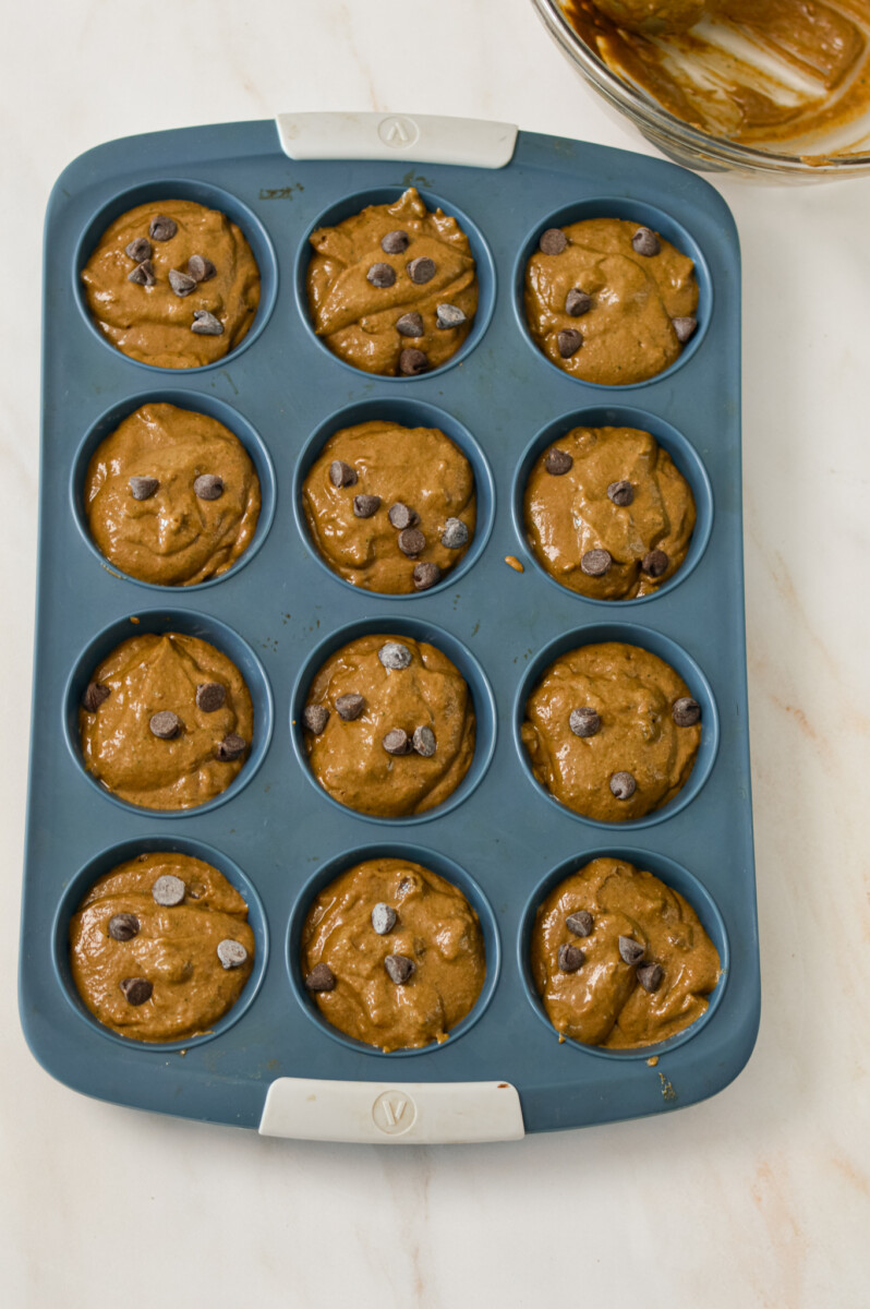 Batter divided into a muffin tray.