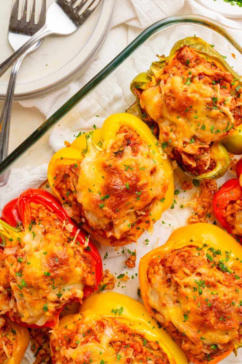 Close up of stuffed peppers cooked in a baking dish.