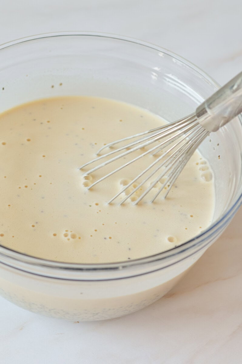 Chia seeds added to the base, being whisked in a mixing bowl.