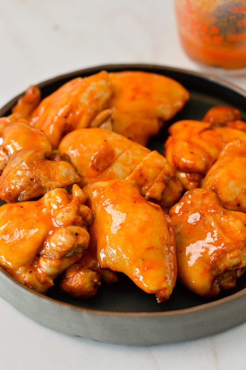 Hot honey chicken thighs on a plate.