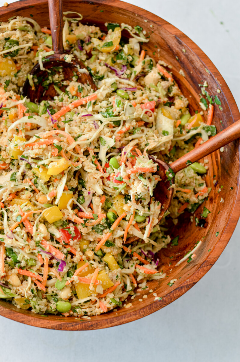 Peanut quinoa salad tossed in a large salad bowl.