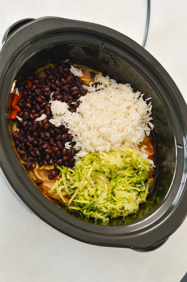 Beans, rice and zucchini added to the slow cooker.