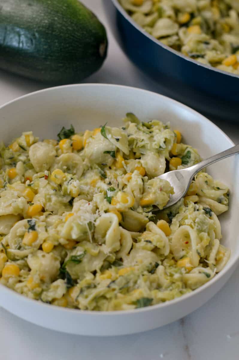 Zucchini pasta in a small bowl with a fork.