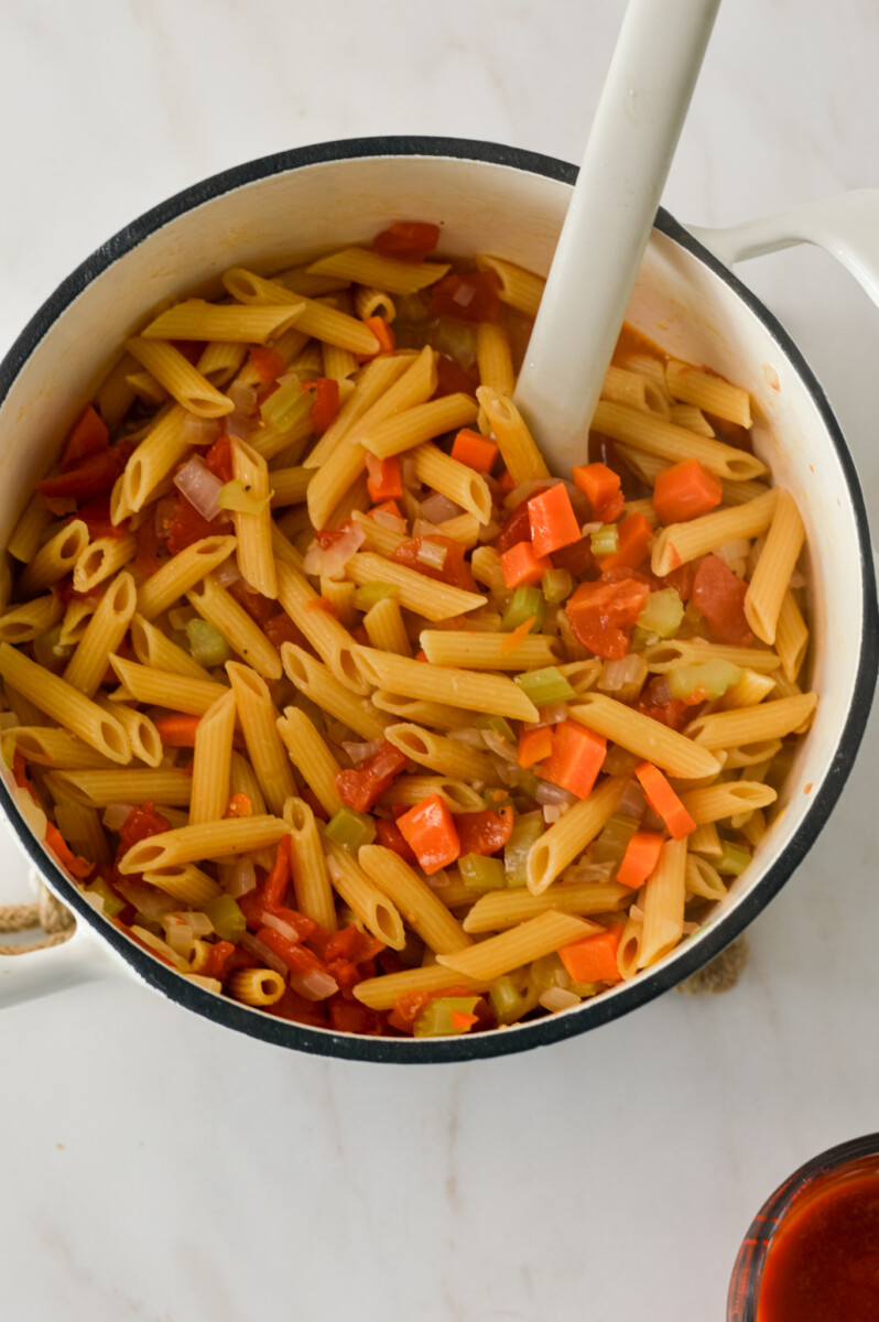 Protein pasta and diced tomatoes added to the mirepoix.