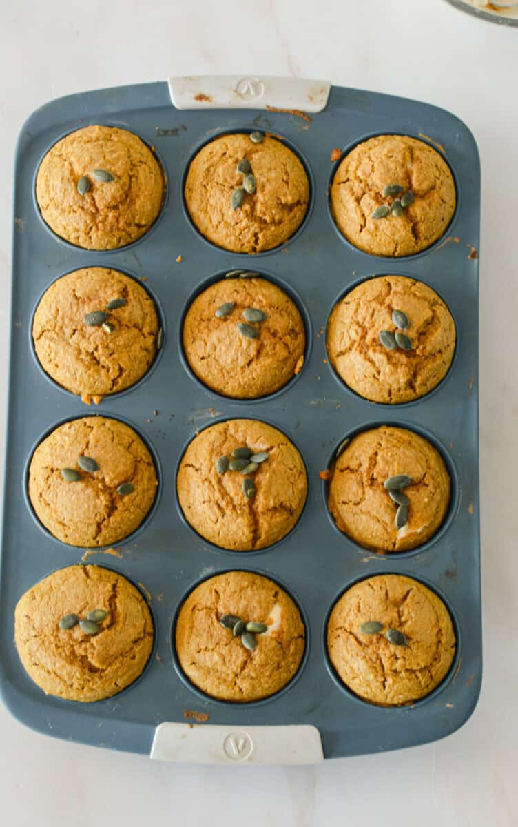 Muffins after baking topped with pumpkin seeds.