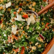 Close up of a salad tong lifting up the Tuscan Kale Quinoa Salad.