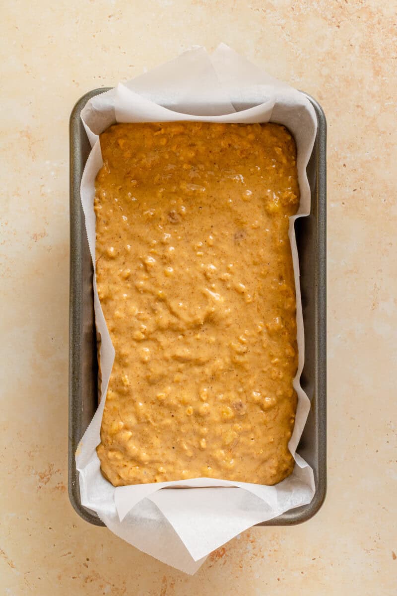 Oat flour banana bread batter added to a loaf pan.