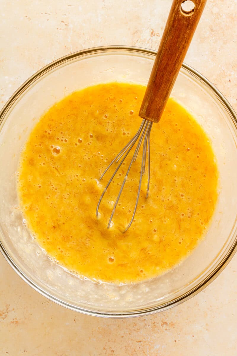 Wet ingredients whisked together in a mixing bowl.