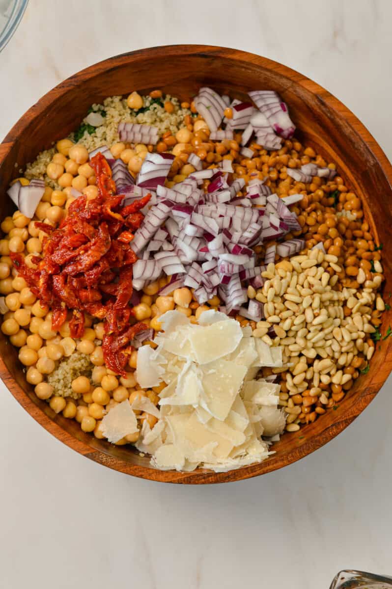 All the tuscan kale salad ingredients added to a large salad bowl.